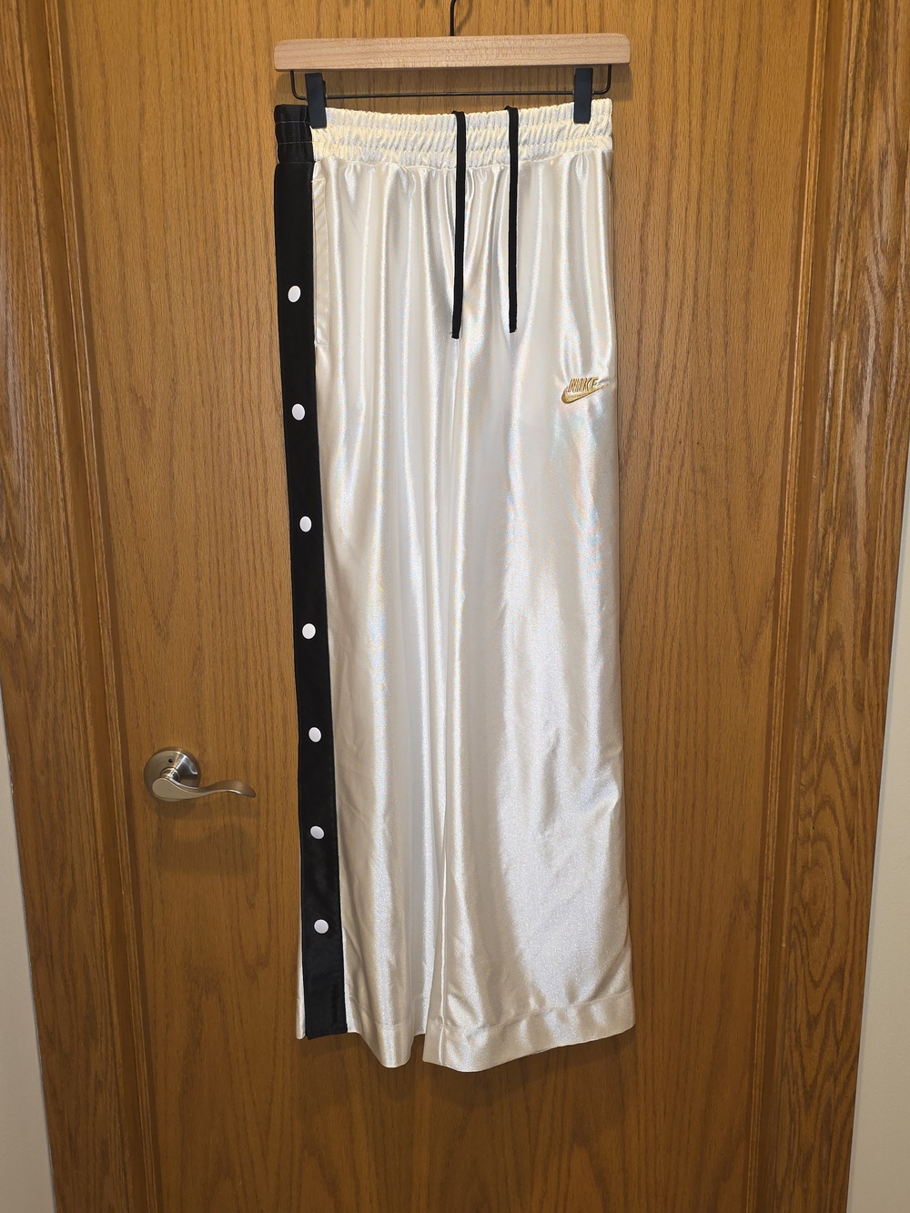 Nike White Track Pants with Black Side Snap Stripe And Gold Nike Logo